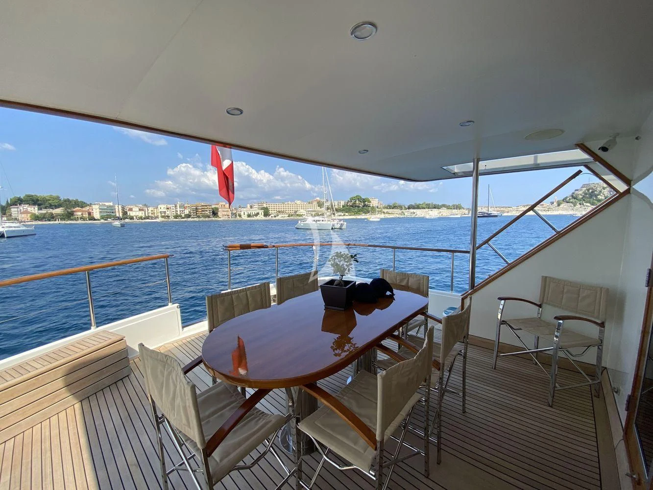 a table on a deck overlooking a body of water aboard STALCA Yacht for Sale