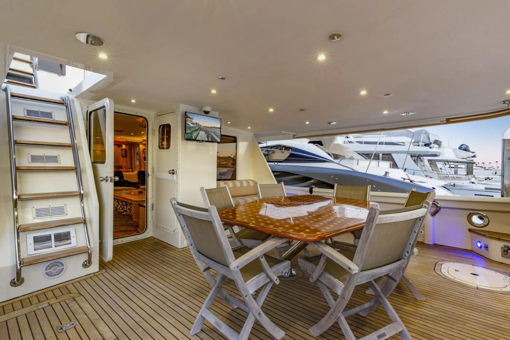 a room with a table and chairs aboard HOLIDAY Yacht for Sale