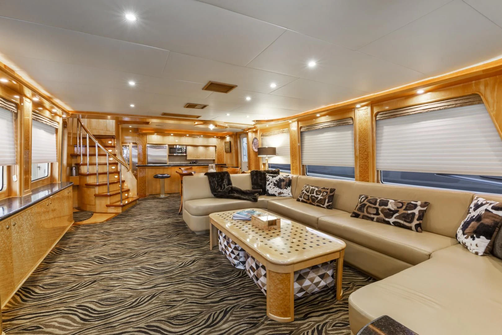 a living room with a large open staircase aboard HOLIDAY Yacht for Sale