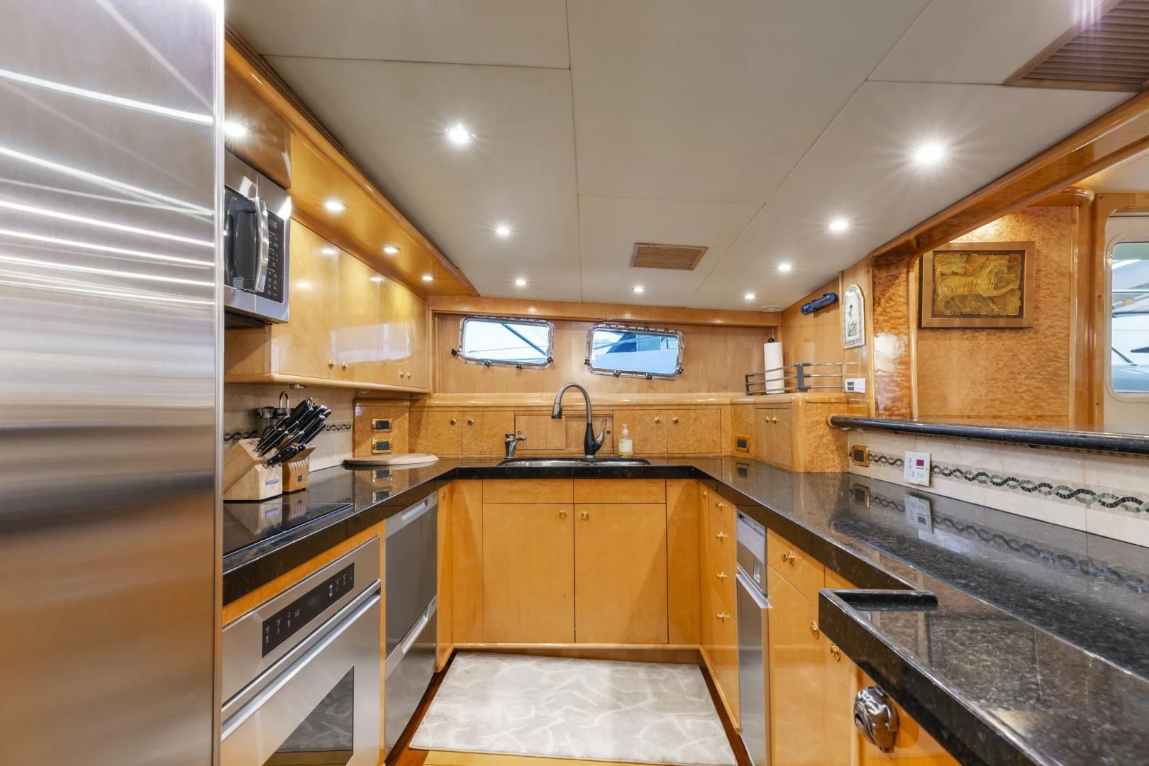 a kitchen with wooden cabinets aboard HOLIDAY Yacht for Sale