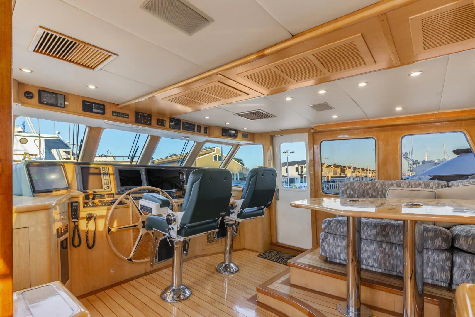 a room with a bar and chairs aboard HOLIDAY Yacht for Sale