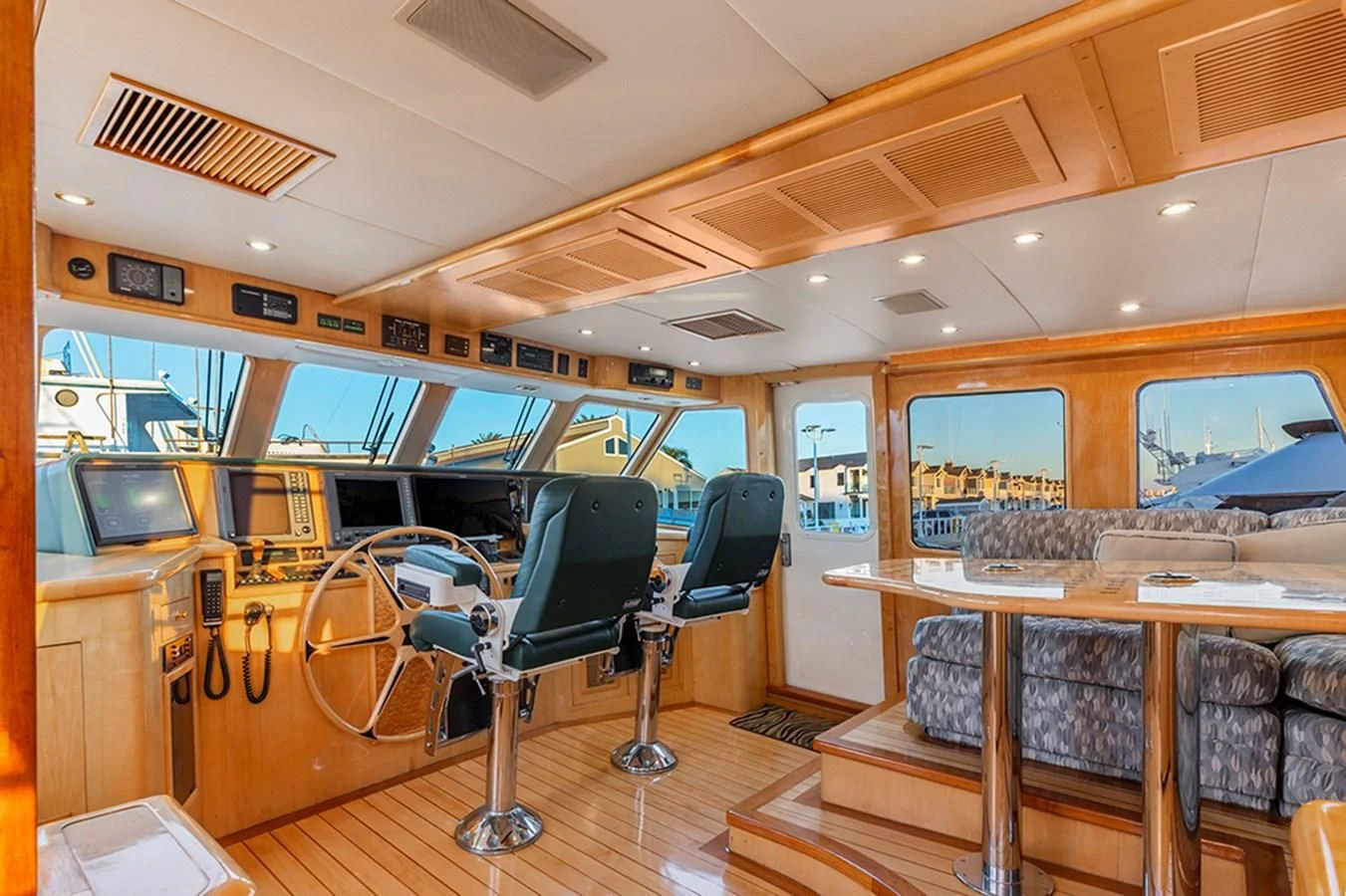 a room with a bar and chairs aboard HOLIDAY Yacht for Sale