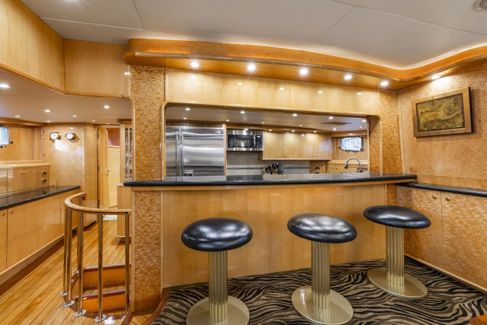 a kitchen with stools and a bar aboard HOLIDAY Yacht for Sale
