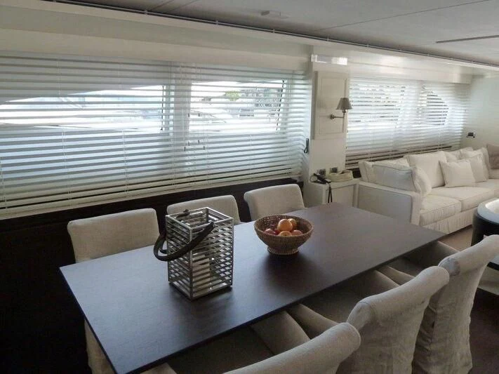 a dining room with a table and chairs aboard TYAMO Yacht for Sale
