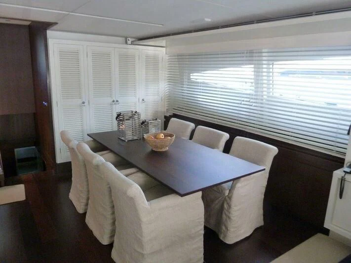 a table and chairs in a room aboard TYAMO Yacht for Sale