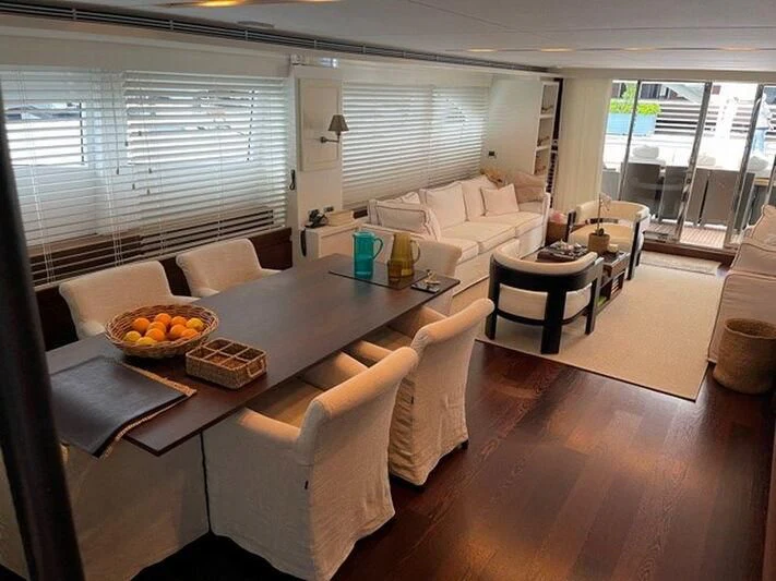 a living room with a table and chairs aboard TYAMO Yacht for Sale