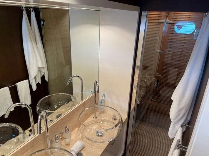 a bathroom with a large mirror aboard TYAMO Yacht for Sale