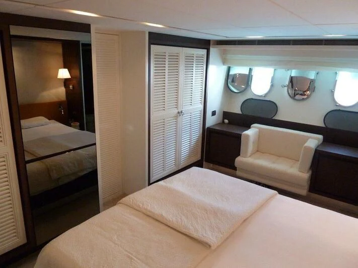 a hotel room with a bed and a chair aboard TYAMO Yacht for Sale
