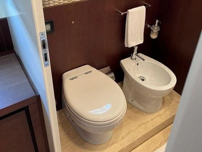 a toilet and sink in a bathroom aboard TYAMO Yacht for Sale
