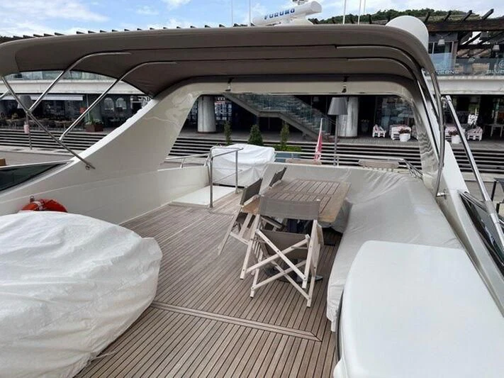 a deck with chairs and tables aboard TYAMO Yacht for Sale