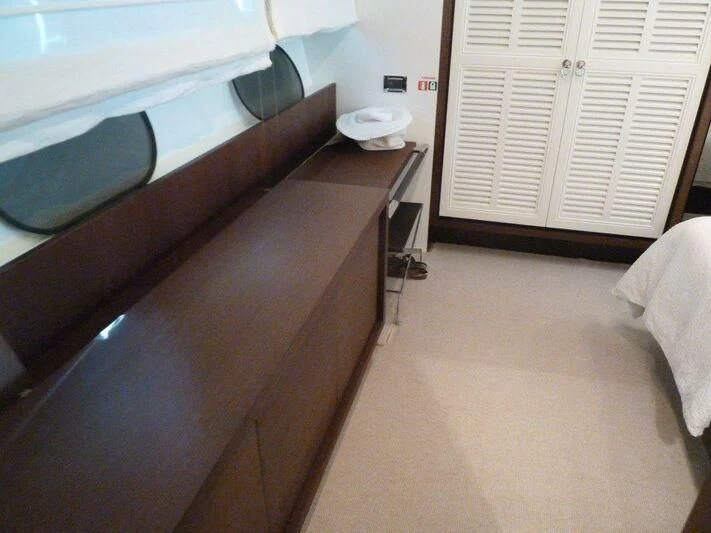 a room with a bed and a desk aboard TYAMO Yacht for Sale