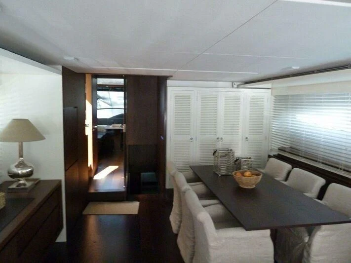 a dining room with a table and chairs aboard TYAMO Yacht for Sale