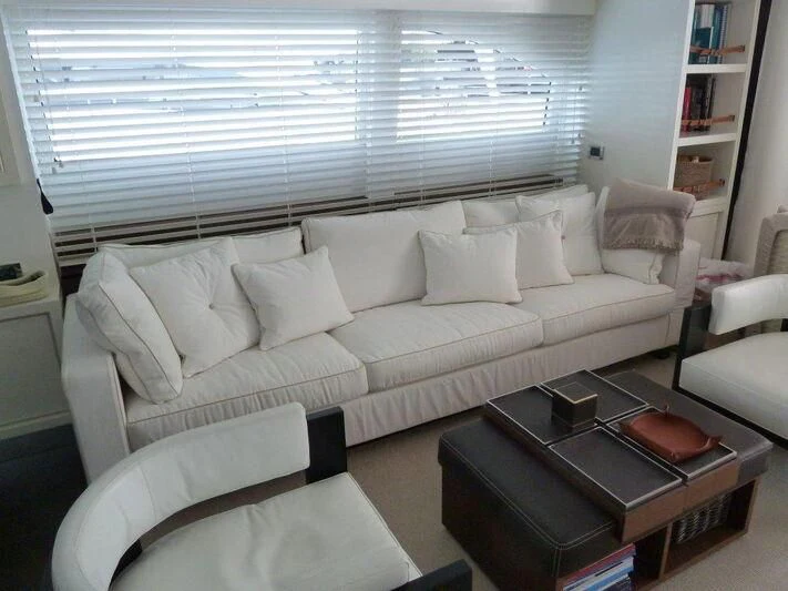 a living room with a white couch aboard TYAMO Yacht for Sale