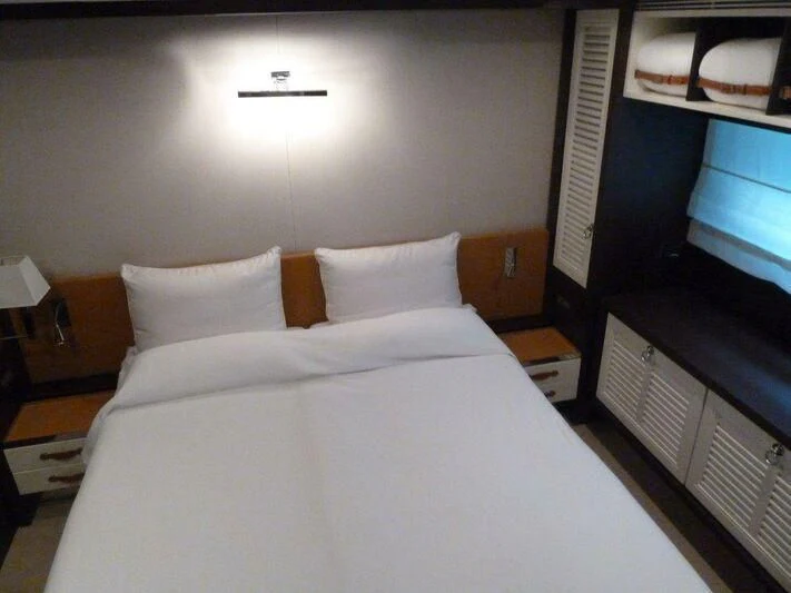 a bed with white sheets aboard TYAMO Yacht for Sale