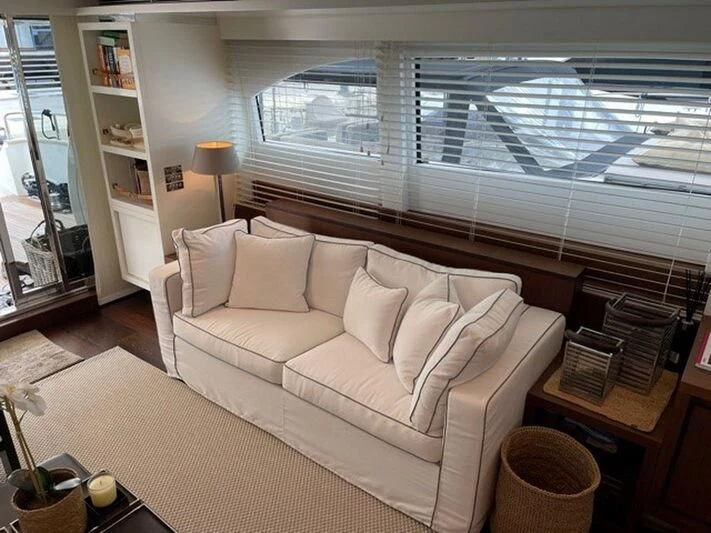 a living room with a large window aboard TYAMO Yacht for Sale