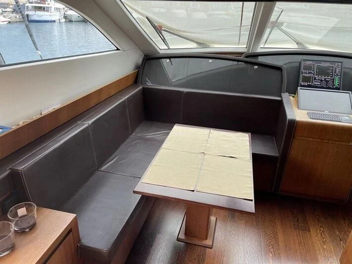 a wooden desk with a computer on it aboard TYAMO Yacht for Sale