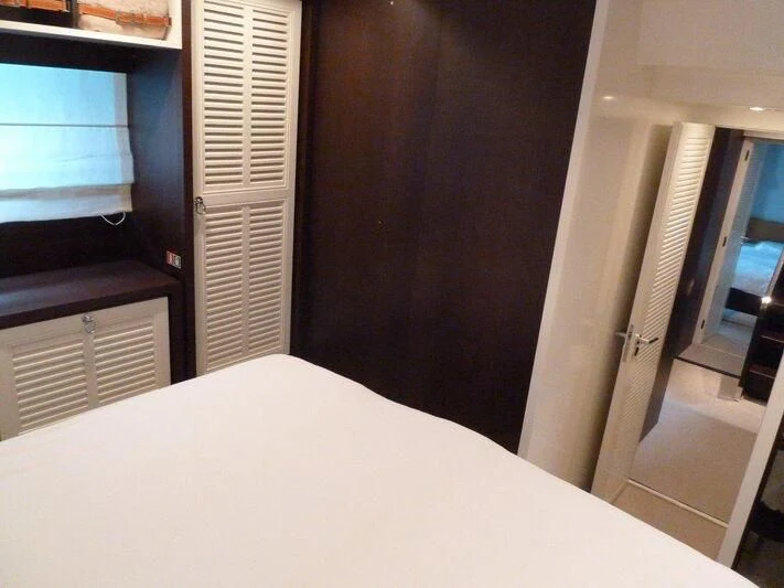 a room with a bed and a window aboard TYAMO Yacht for Sale