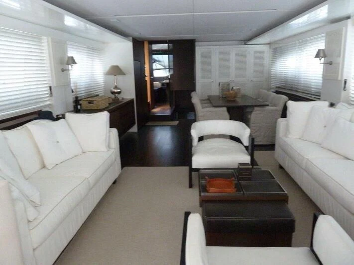 a living room with white couches aboard TYAMO Yacht for Sale