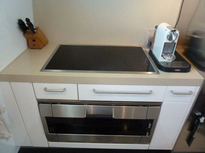 a kitchen with a stove and a toaster oven aboard TYAMO Yacht for Sale