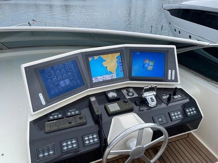 a car with a screen and a couple of screens on the dashboard aboard TYAMO Yacht for Sale