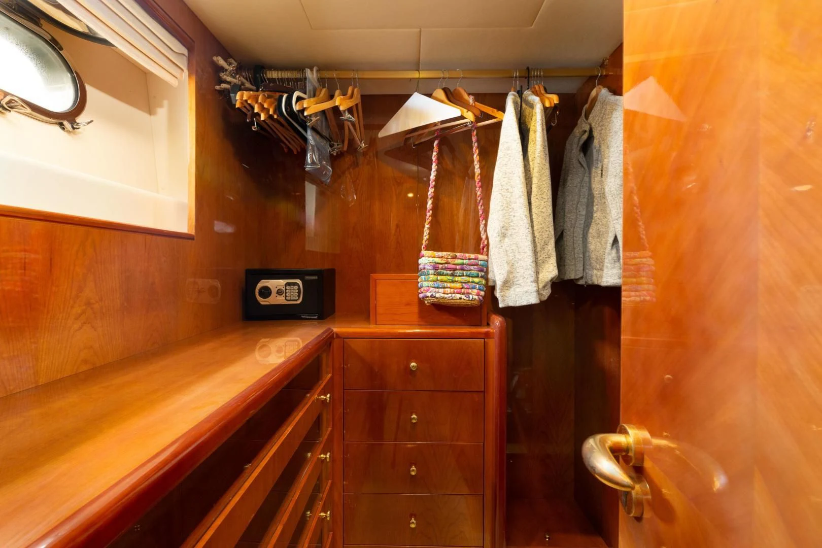 a closet with clothes on the wall aboard GRAVITY Yacht for Sale