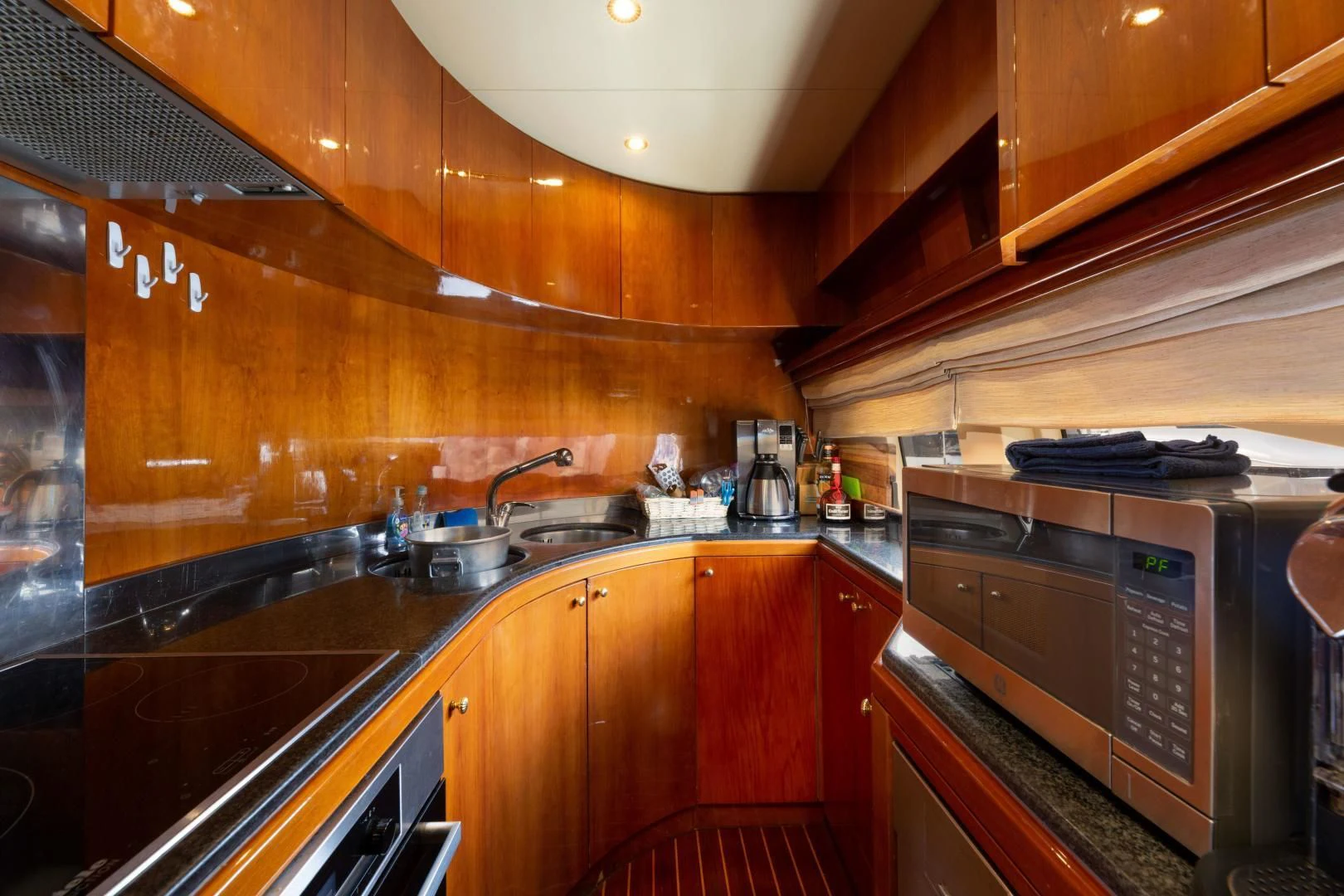 a kitchen with wooden cabinets aboard GRAVITY Yacht for Sale