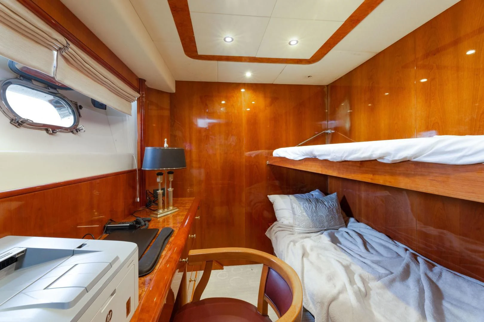 a room with a bed and a desk aboard GRAVITY Yacht for Sale