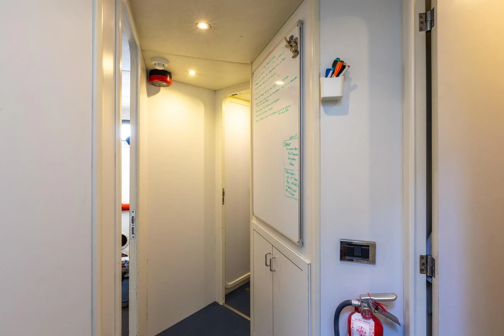 a hallway with doors aboard GRAVITY Yacht for Sale