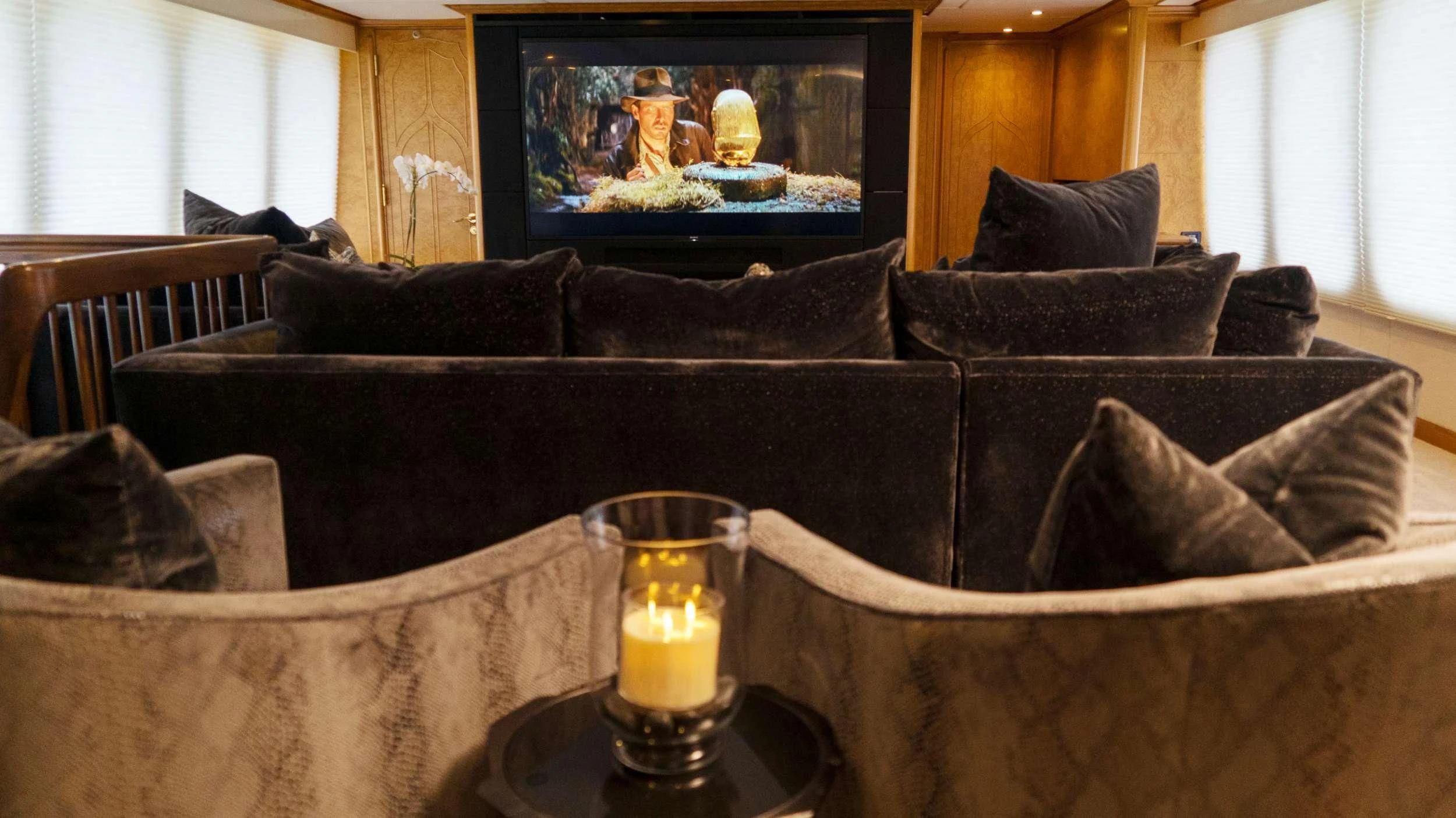 a couch with a glass of beer on it aboard GRAND ILLUSION Yacht for Sale