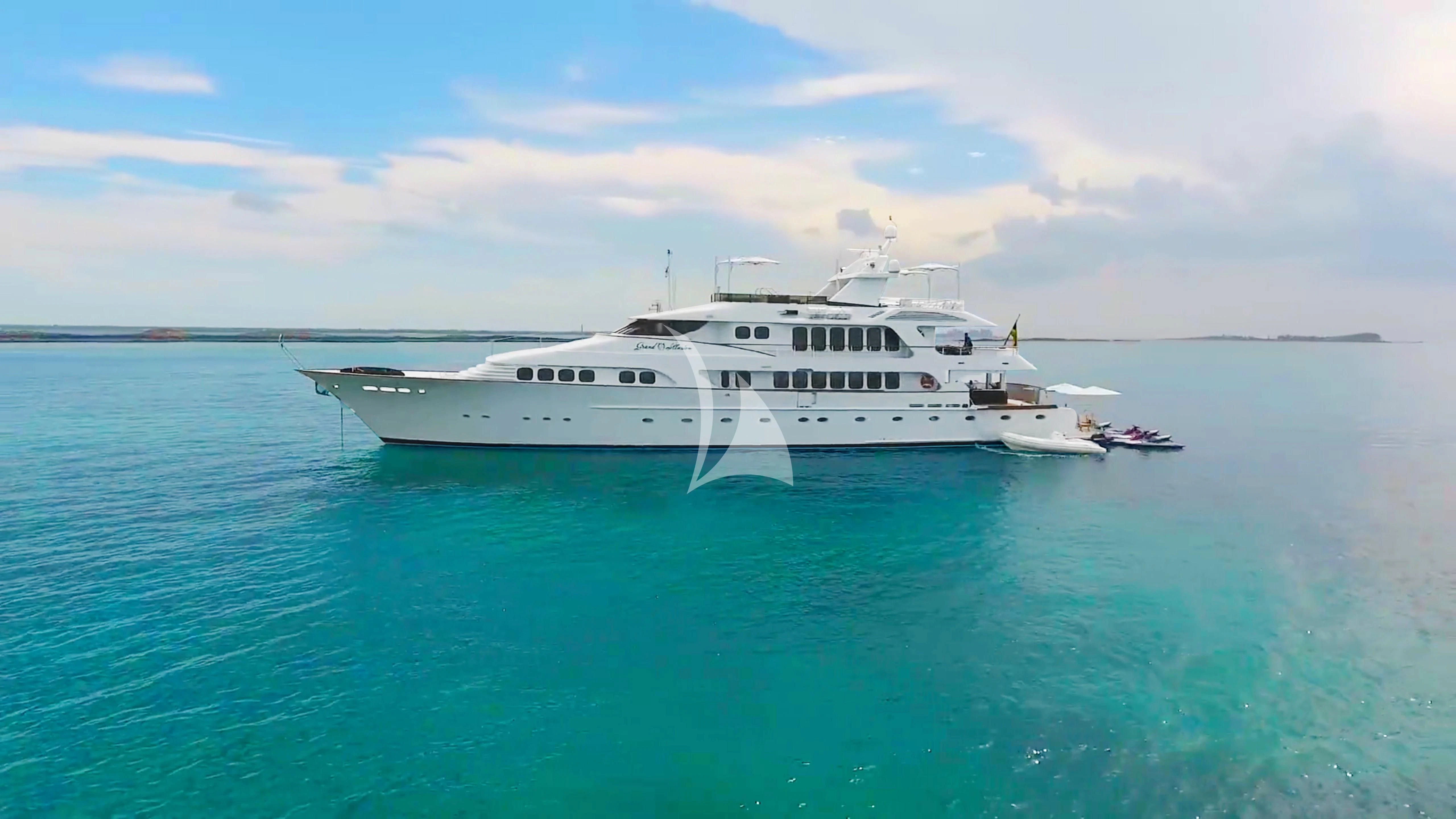 a white yacht in the water aboard GRAND ILLUSION Yacht for Sale