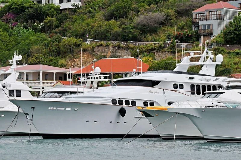 a few white yachts in the water aboard GRAND ILLUSION Yacht for Sale