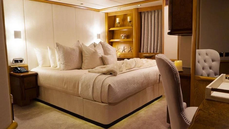 a bed in a room aboard GRAND ILLUSION Yacht for Sale