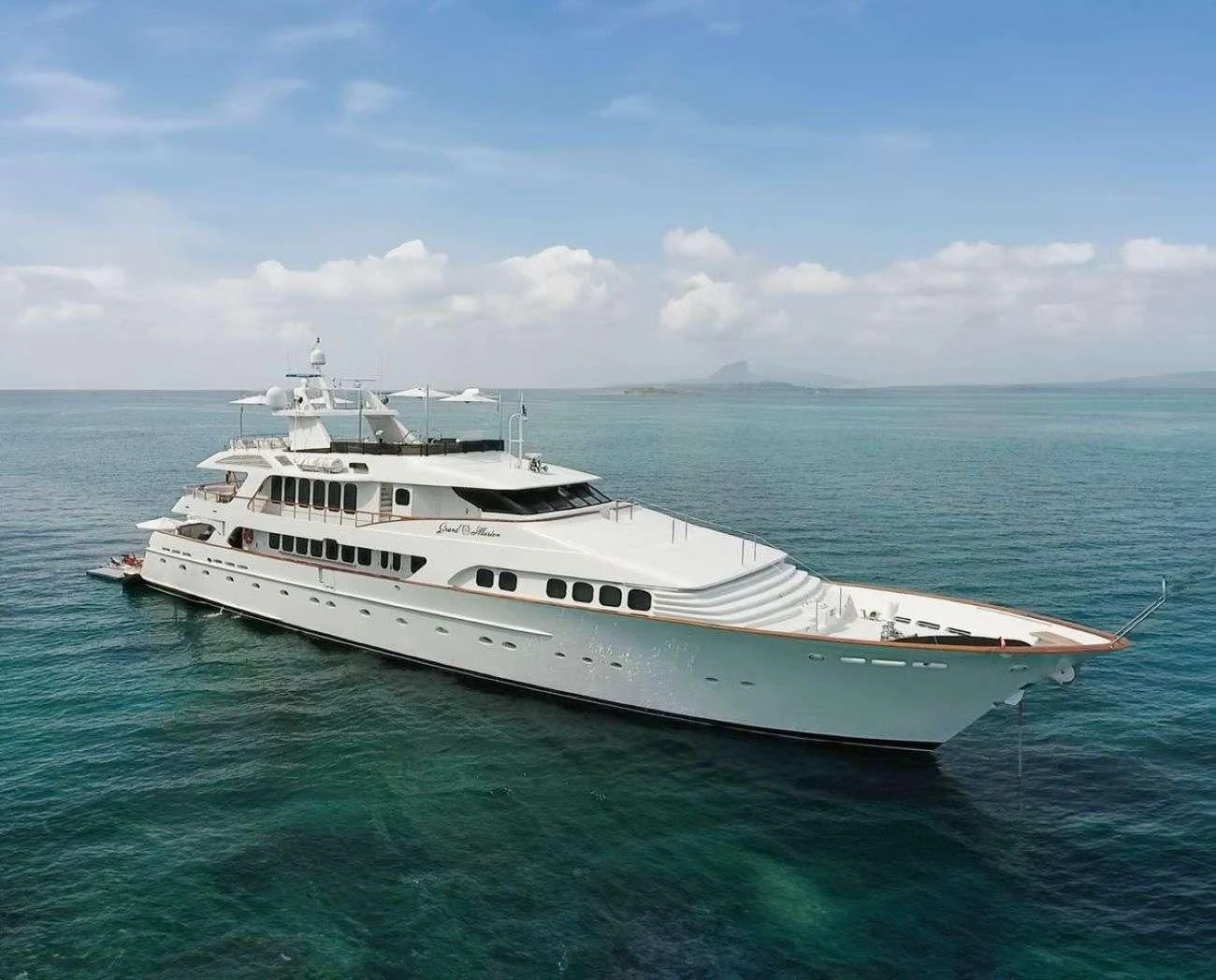 a white yacht in the ocean aboard GRAND ILLUSION Yacht for Sale