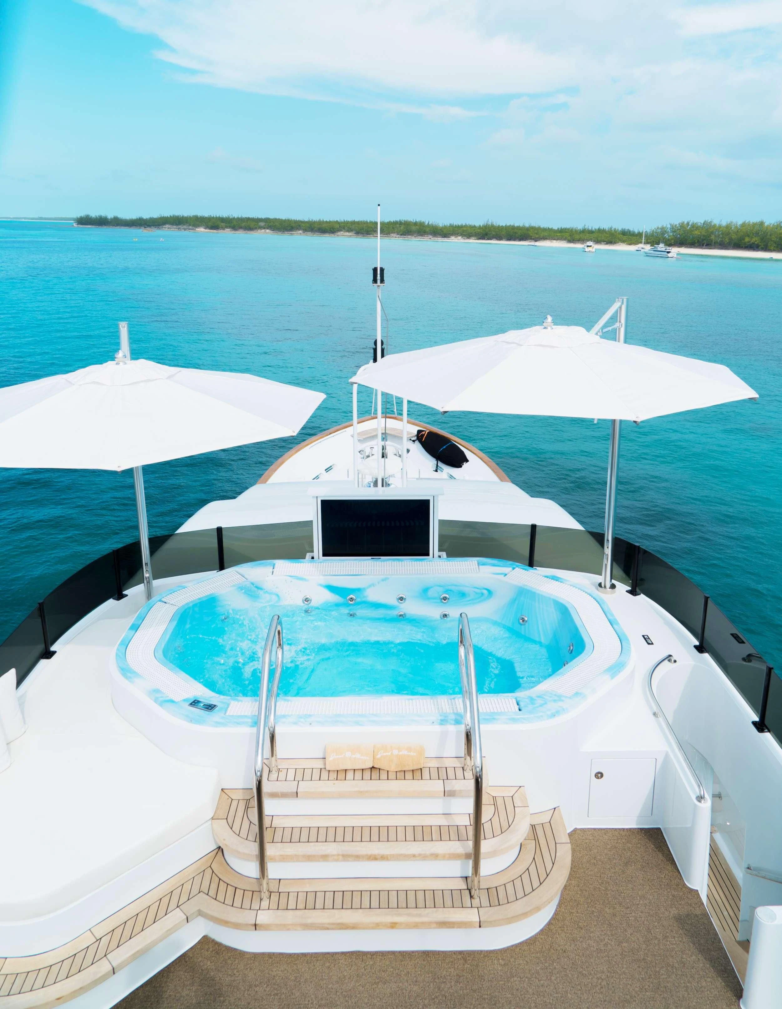 a couple of umbrellas sit on a boat aboard GRAND ILLUSION Yacht for Sale