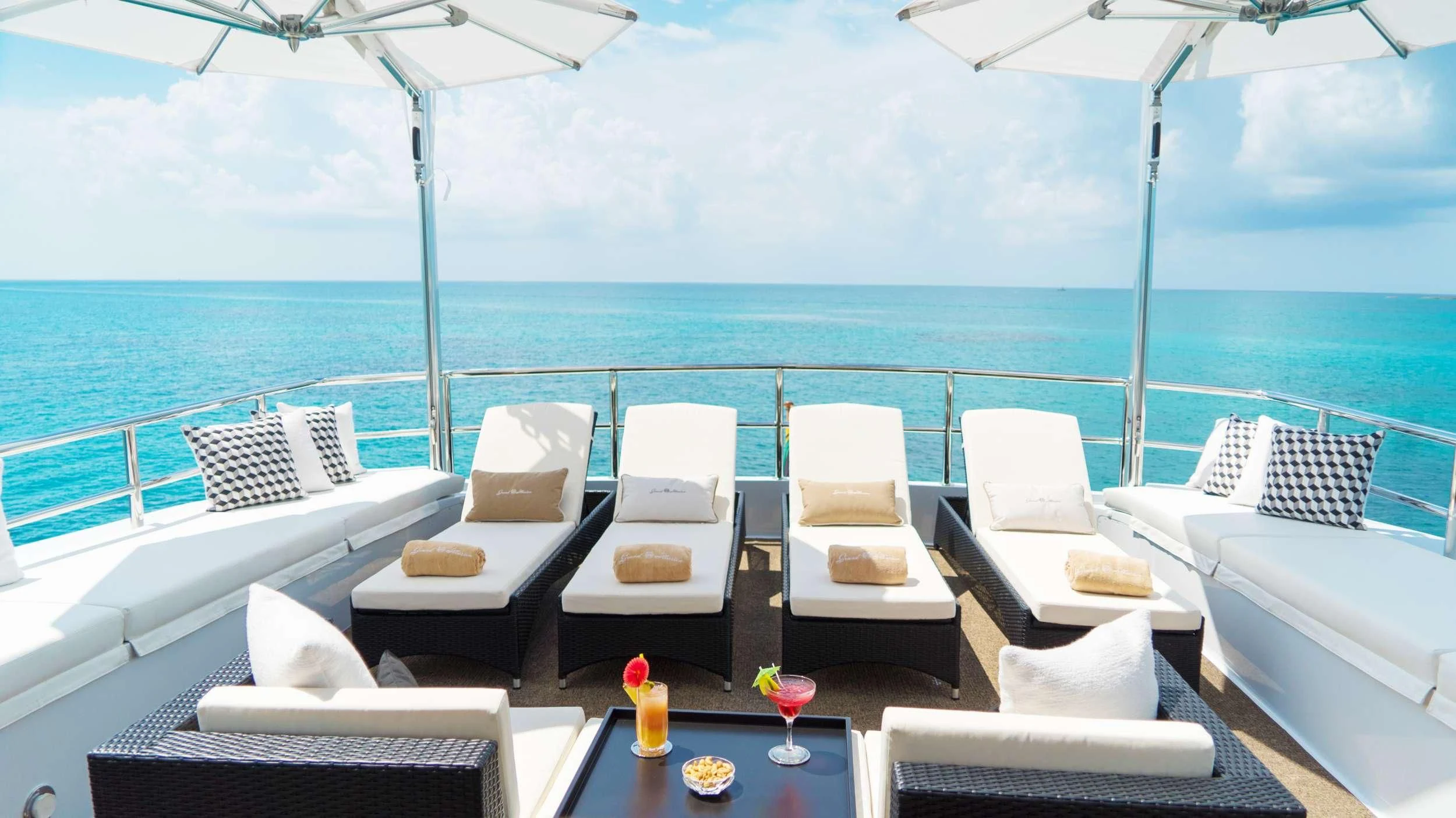 a room with a table chairs and a large body of water aboard GRAND ILLUSION Yacht for Sale