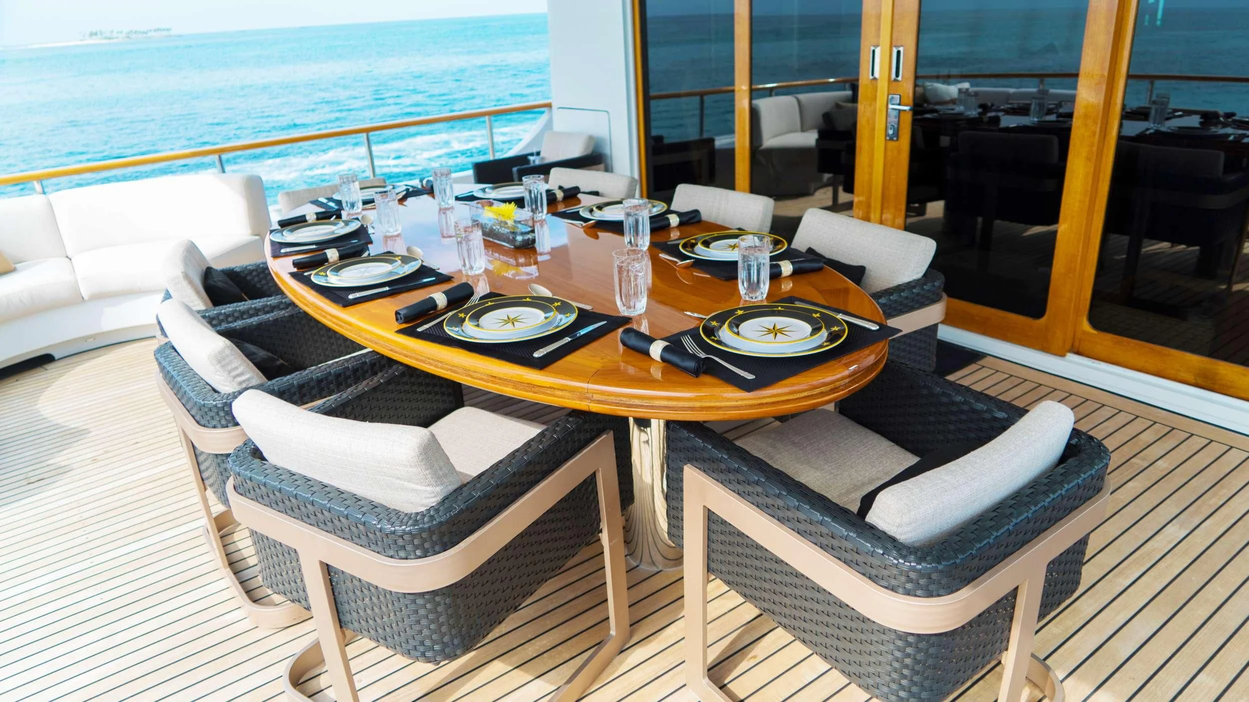 a table with plates and chairs on it aboard GRAND ILLUSION Yacht for Sale