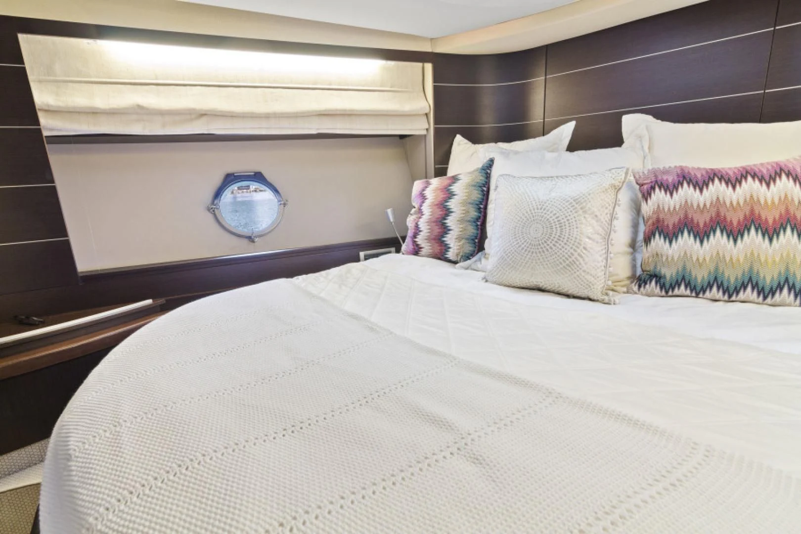 a bed with a white sheet and pillows on it aboard BLIND SQUIRREL Yacht for Sale