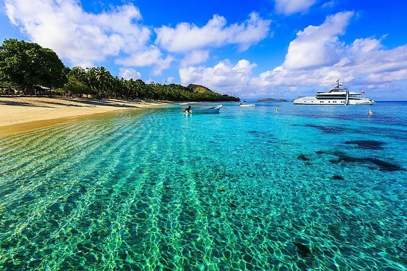 a beach with a couple of boats in the water aboard STEFANIA Yacht for Sale