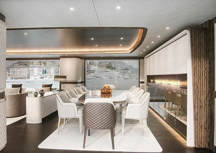 a room with a table chairs and a couch aboard STEFANIA Yacht for Sale