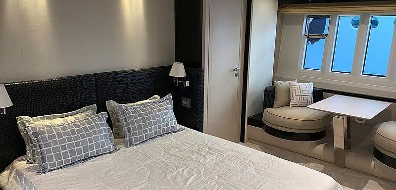 a bed with pillows and a table aboard BELLA TWO Yacht for Sale