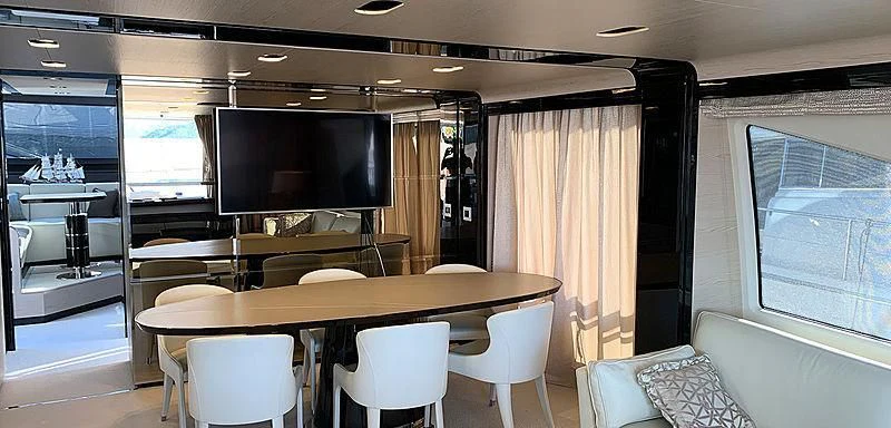 a room with a table and chairs aboard BELLA TWO Yacht for Sale