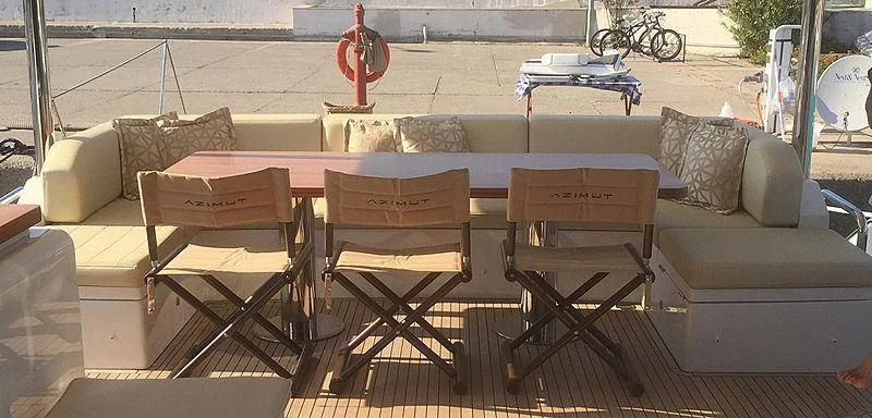 a table with chairs around it aboard BELLA TWO Yacht for Sale