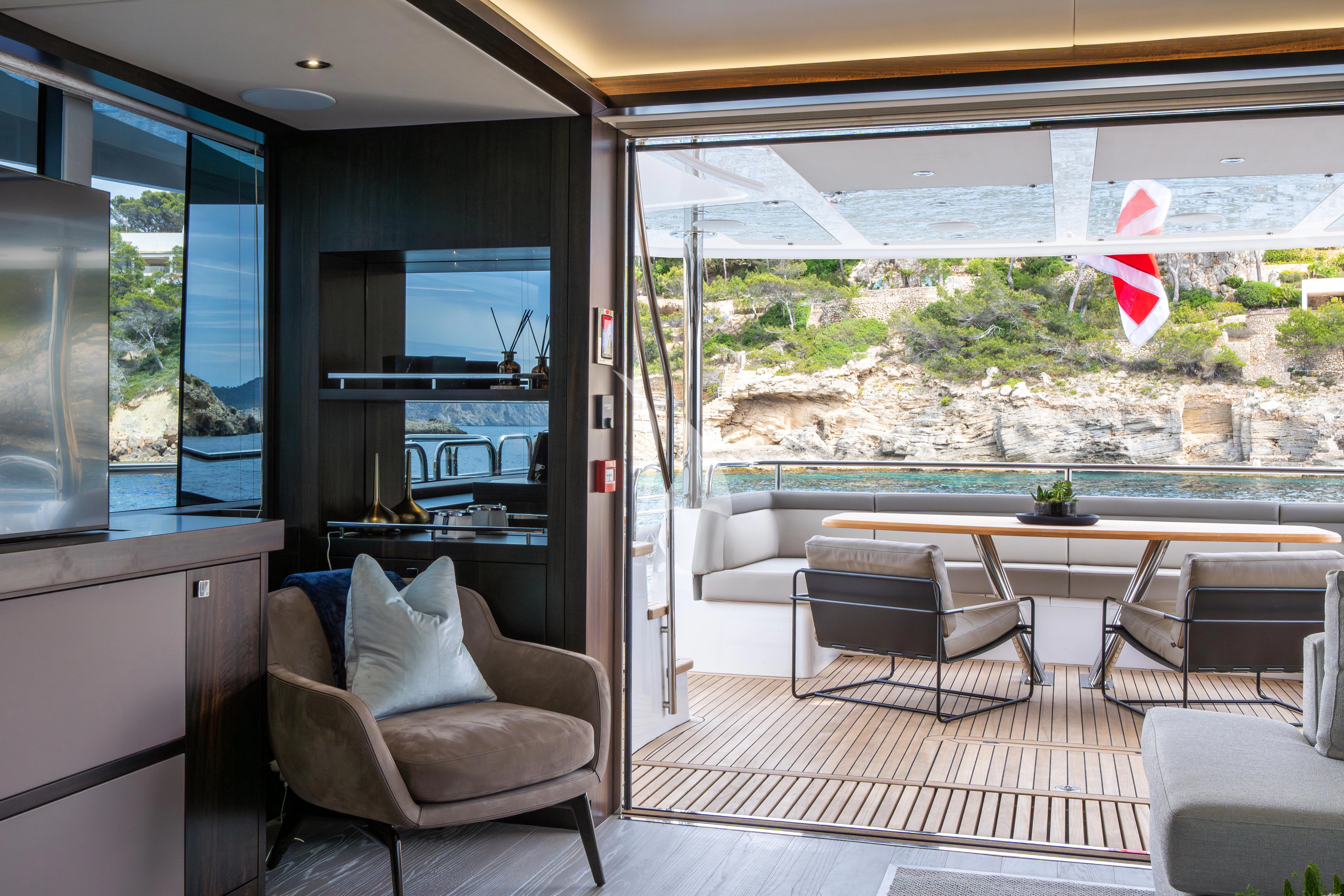 a room with a table chairs and a large window aboard BLUE INFINITY ONE Yacht for Sale