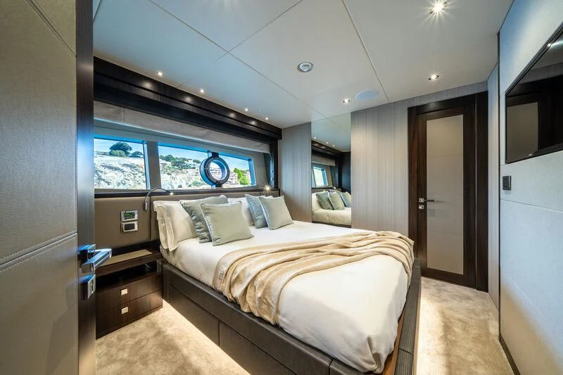 a bedroom with a bed and a window aboard BLUE INFINITY ONE Yacht for Sale