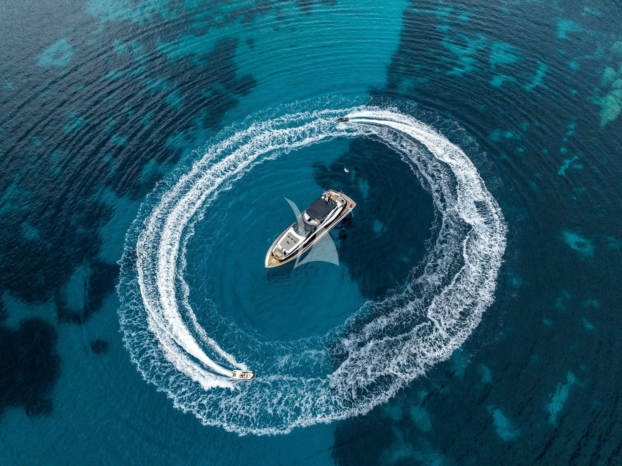 a car driving on a water body with Great Blue Hole in the background aboard BLUE INFINITY ONE Yacht for Sale