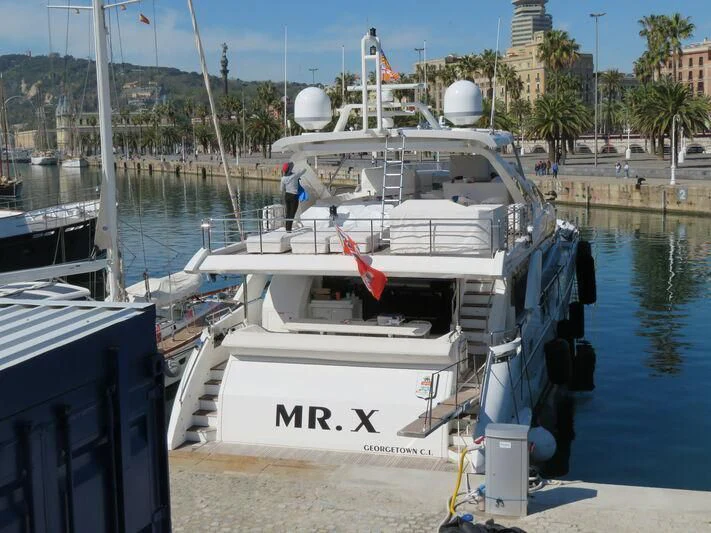 a boat docked at a pier aboard MR. X Yacht for Sale