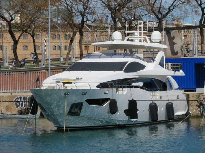 a boat docked at a pier aboard MR. X Yacht for Sale