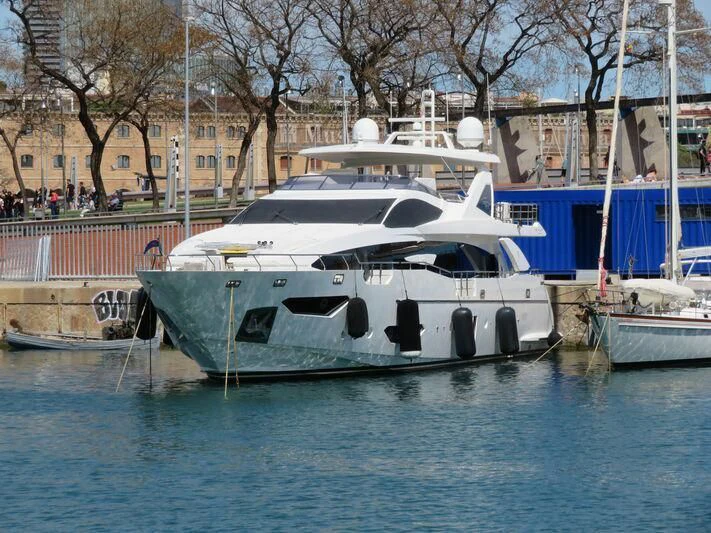 a boat docked at a pier aboard MR. X Yacht for Sale