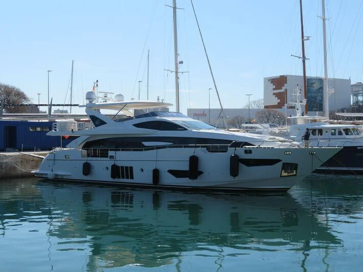 a white yacht in a harbor aboard MR. X Yacht for Sale