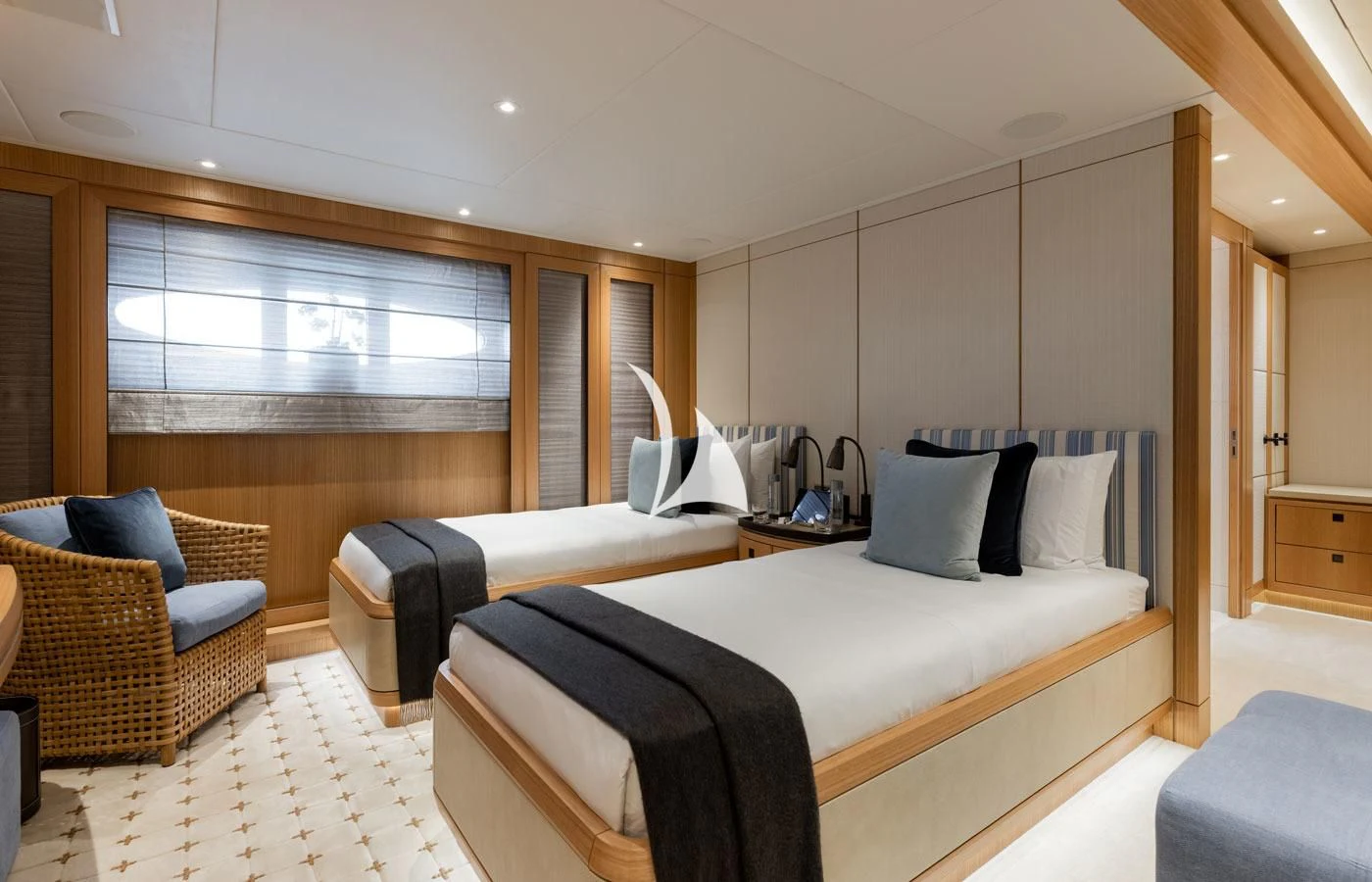 a room with a bed and a chair aboard VENTUM MARIS Yacht for Charter